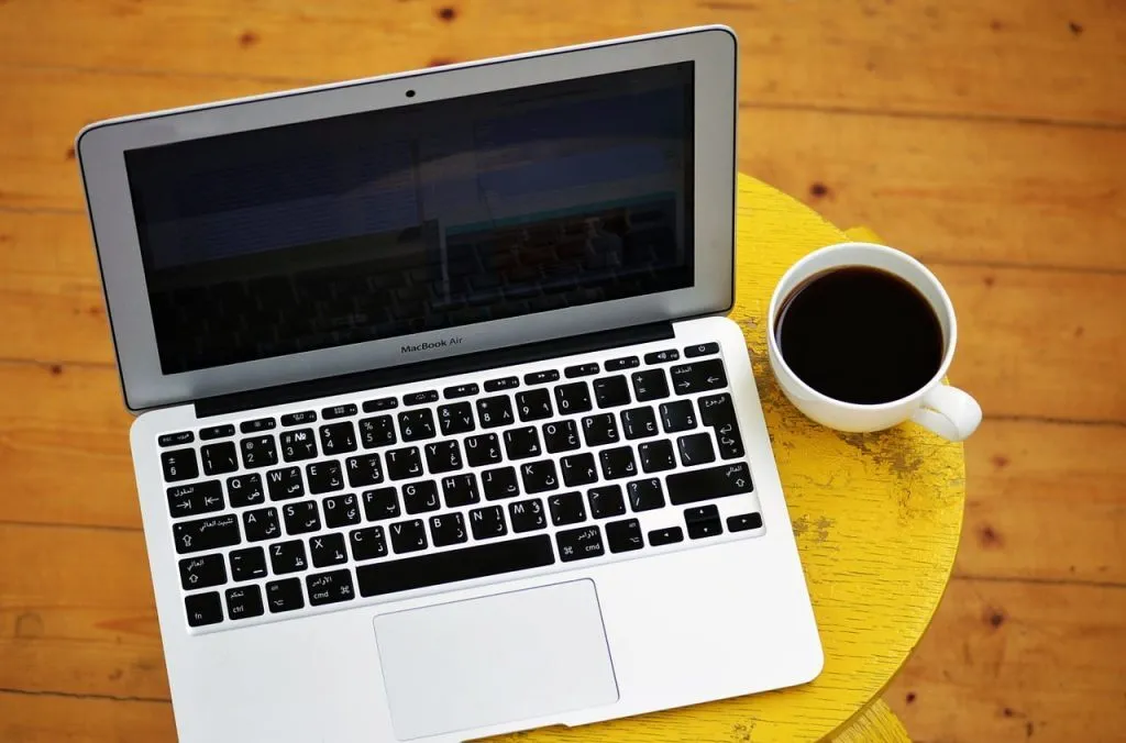 a laptop and a cup of coffee