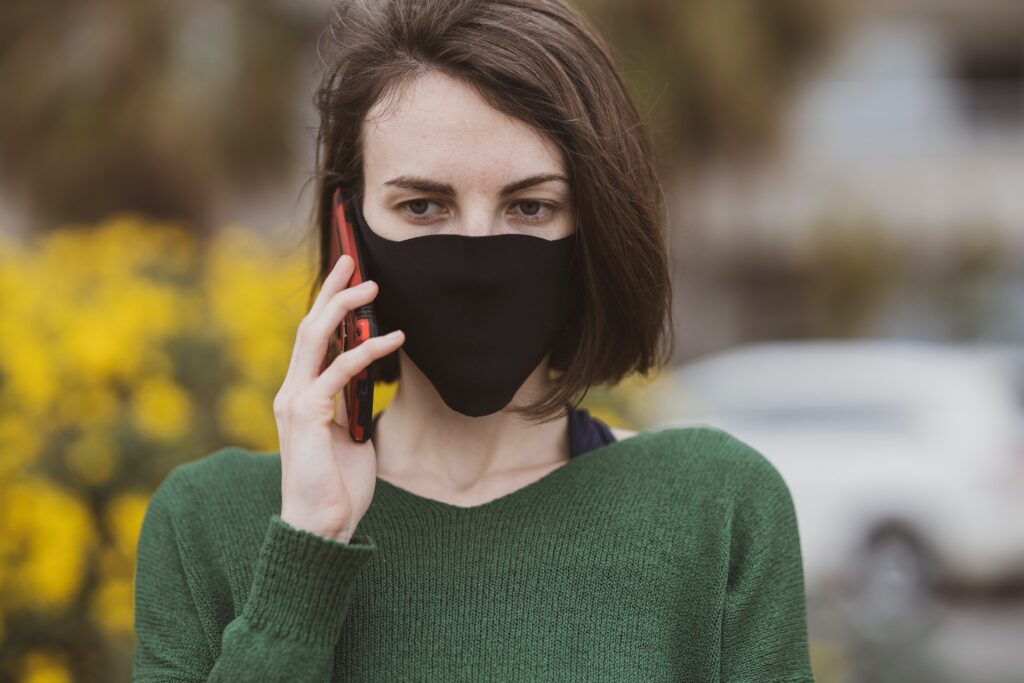 How VoIP System is Helping Businesses Improve Call Connectivity Globally 1 holding black mask